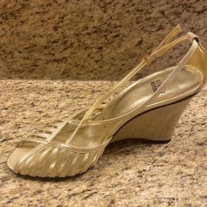 Metallic gold strapped 3 1/2 wedge. New in box. Size 9.